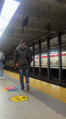 Evening commuters navigate Buenos Aires subway platform safety protocols