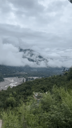 Unfinished construction meets cloudy mountain views in Vashisht