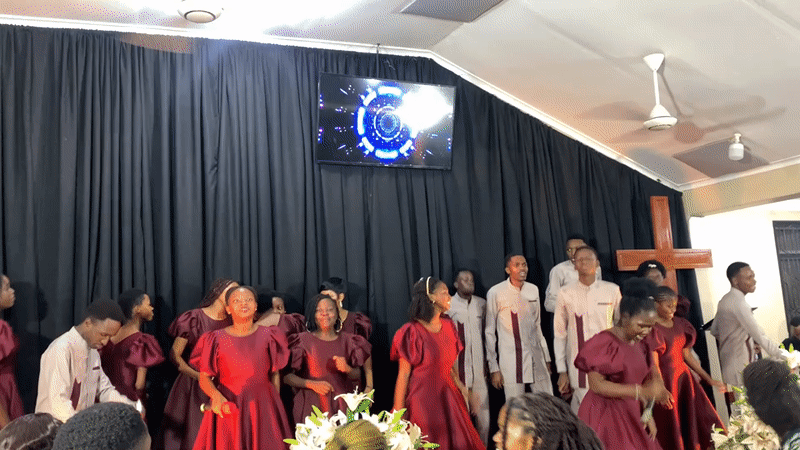 Choir performs in matching maroon uniforms on Dar es Salaam stage