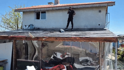 Man takes phone call on rooftop in Kalchevo