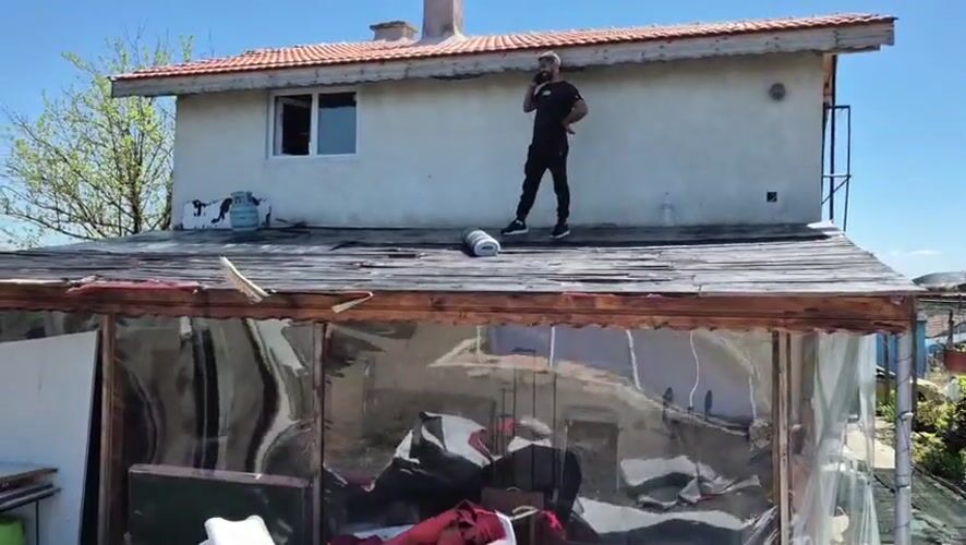 Man takes phone call on rooftop in Kalchevo