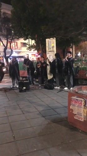 Young musicians busk with traditional instruments in La Paz plaza