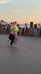 Couples dance on Astrakhan's Volga riverfront at sunset