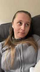 Woman relaxes with tea on couch in Montenegro