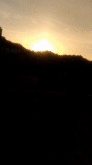 Sunrise to midday skies over Caracas, contrails and hillside barrios