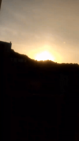 Sunrise to midday skies over Caracas, contrails and hillside barrios