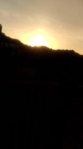 Sunrise to midday skies over Caracas, contrails and hillside barrios