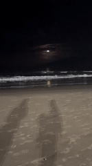 Moonlit beach vigil captured at Florianópolis shrine
