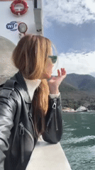 Woman documents scenic Montenegro ferry crossing on Bay of Kotor