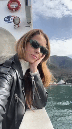 Woman documents scenic Montenegro ferry crossing on Bay of Kotor