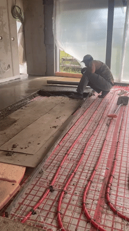 Construction worker documents concrete pouring project in Krasnodar
