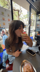 Woman spends afternoon at Tel Aviv cafe amid city architecture