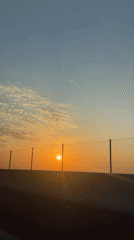 Sunset observed from moving vehicle in Massalfassar, Spain