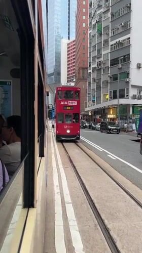 Hong Kong trams pass in early morning transit moment