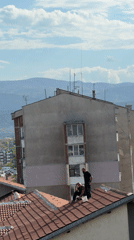 Workers perform rooftop maintenance on homes in Plovdiv