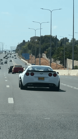 White Corvette C6 on a sunny Israeli highway