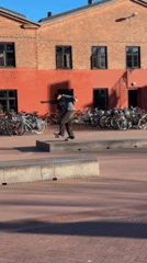 Skateboarders practice tricks in Copenhagen plaza on sunny afternoon