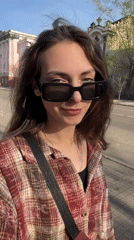 Woman films herself walking through sunny Krasnoyarsk streets