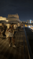 Rooftop dancing in Baku with the city skyline at night