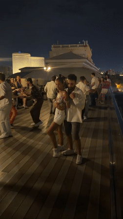 Rooftop dancing in Baku with the city skyline at night