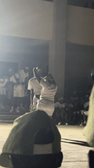 Two people in white attend nighttime outdoor event in Maiduguri