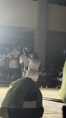 Two people in white attend nighttime outdoor event in Maiduguri