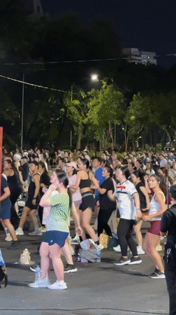 Outdoor group fitness session lights up a Bangkok night