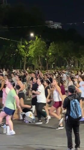 Outdoor group fitness session lights up a Bangkok night
