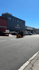 Forklift moves pallets at Barcelona fruit distribution facility