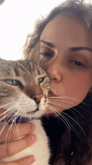Woman and cat enjoy afternoon forest walk with treats