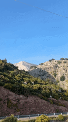 Tourist documents scenic drive through Fethiye's mountainous coastline