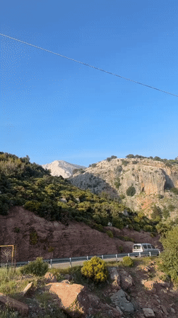 Tourist documents scenic drive through Fethiye's mountainous coastline