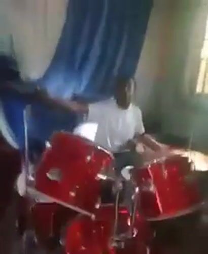 Drummer performs in church hall, Umuode Nigeria