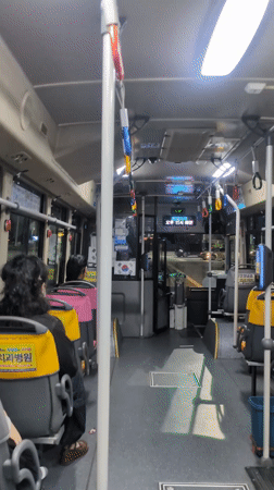 Bus passengers travel through Busan on afternoon route