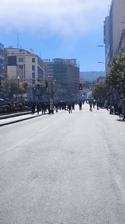 Large crowds gather, move through central La Paz streets