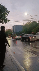 Post-rain street activity captured in central Dhaka