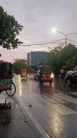 Post-rain street activity captured in central Dhaka