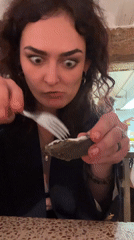 Woman enjoys oyster dinner at Valencia restaurant