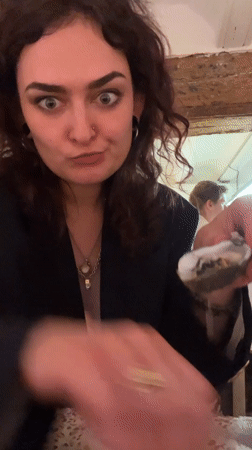 Woman enjoys oyster dinner at Valencia restaurant