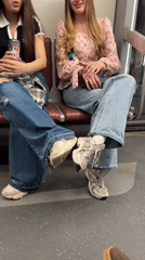Two women ride Saint Petersburg Metro together Friday afternoon