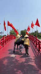 Morning activity observed on flag-lined bridge in Đà Nẵng