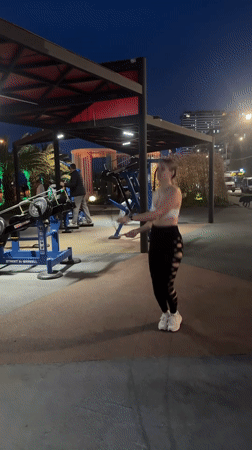 Woman jump ropes at outdoor gym in Batumi evening
