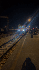 Evening train arrives at Podgorica station with waiting passengers