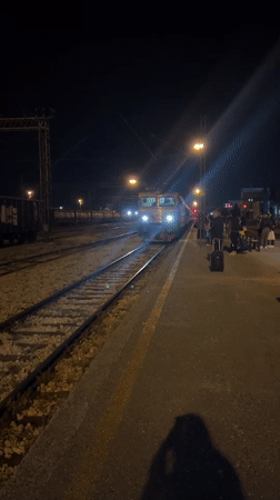 Evening train arrives at Podgorica station with waiting passengers