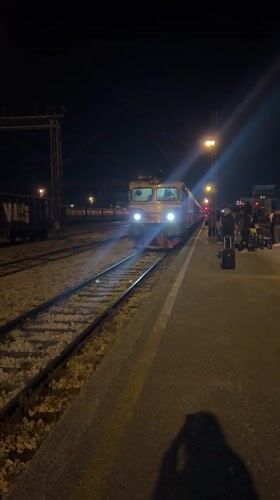 Evening train arrives at Podgorica station with waiting passengers