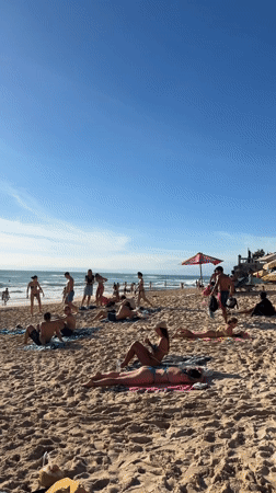 Busy morning beach scene captured at Kuta Selatan