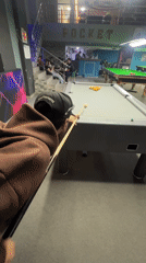 Man plays billiards at Meknes pool hall