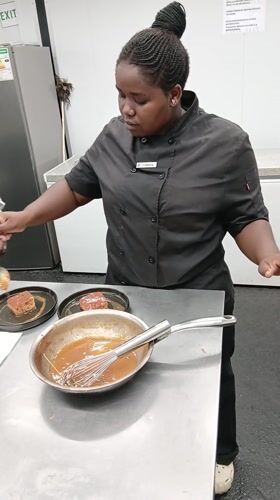 Chef prepares charcuterie board in Botswana commercial kitchen