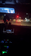 Ambulance with flashing lights travels Hagonoy road at night