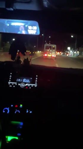 Ambulance with flashing lights travels Hagonoy road at night